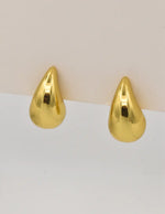 Molten gold hoop earrings with teardrop shape close-up