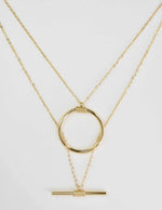 dainty gold necklace featuring circular and horizontal bar