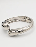 Silver metallic bangle on a white background