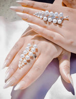 Pearl bracelet on a hand with a soft focus background