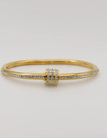 Gold bangle with triple-ring silver-stone centre design