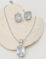 radiant_glamour_silver_set sterling silver necklace and crystal earrings displayed on shell, montreal minimalist jewelry gift for her