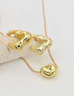 bold gold necklace with statement pendant and sculptural earrings, TikTok viral necklaces Canada