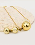 gold radiant orb duo set featuring round pendant necklace and matching stud earrings montreal minimalist jewelry clean girl style