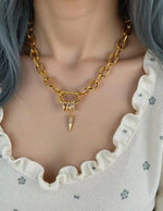 Close-up of crystal-studded spike on chunky chain