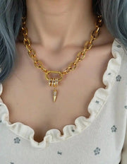 Close-up of crystal-studded spike on chunky chain