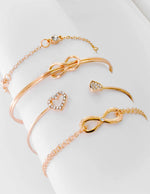 Gold heart and knot friendship bracelets stack on white background