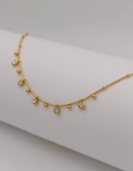 Minimalist gold necklace with dainty zircon and bead charms