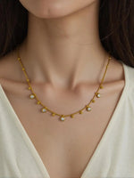 Peoples jewelry necklace with polished gold beads and sparkle stones