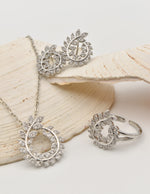 close up of luxe leaf swirl sparkle earrings and necklace, layering necklaces for women, tiktok viral jewellery in canada