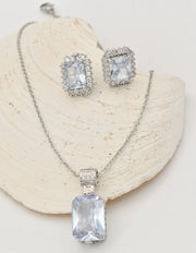 radiant_glamour_silver_set sterling silver necklace and crystal earrings displayed on shell, montreal minimalist jewelry gift for her