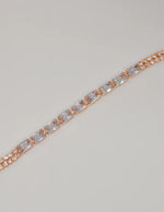 radiant_twilight_permanent_bracelet – american jewelry rose gold bracelet with baguette crystals on shell background