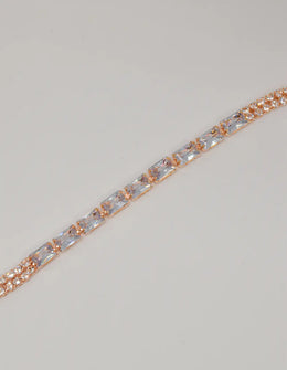 radiant_twilight_permanent_bracelet – american jewelry rose gold bracelet with baguette crystals on shell background