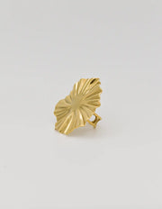 Close-up of radiant gold ring with adjustable band on display